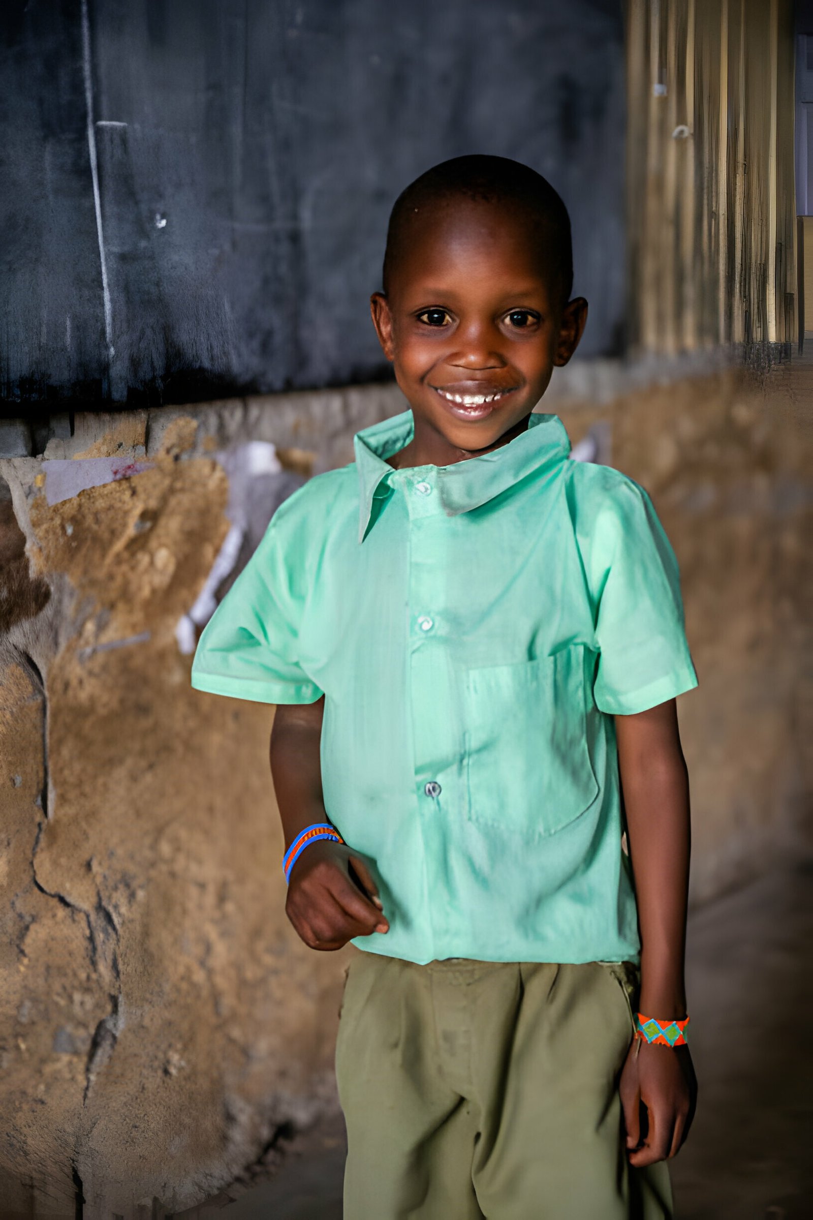 Poor African Boy smiling at school